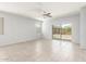 Bright living room featuring tile floors, ceiling fan, and sliding glass door to the backyard at 1239 E Elaine St, Casa Grande, AZ 85122