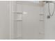 Shower stall featuring white subway tile and built-in shelving at 1239 E Elaine St, Casa Grande, AZ 85122