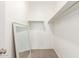 Walk in closet with carpet flooring, a mirror, and built in shelves at 1239 E Elaine St, Casa Grande, AZ 85122