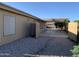 Large backyard with gravel and concrete areas, shade structure, ideal for outdoor activities and low maintenance landscaping at 13031 W Surrey Ave, El Mirage, AZ 85335