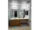 This bathroom boasts dual mirrors, and a long vanity countertop at 13031 W Surrey Ave, El Mirage, AZ 85335