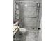 Bathroom featuring tiled shower with grab bars and hexagon tile flooring at 13031 W Surrey Ave, El Mirage, AZ 85335