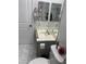 Bathroom with marbled tile floor, toilet and white sink with mirror above at 13031 W Surrey Ave, El Mirage, AZ 85335