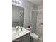 This updated bathroom features a walk-in shower, sleek fixtures, and a modern vanity with a large mirror at 13031 W Surrey Ave, El Mirage, AZ 85335
