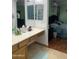 The en suite bathroom boasts dual mirrors and is adjacent to the main bedroom at 13031 W Surrey Ave, El Mirage, AZ 85335