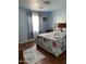 Bright bedroom with wood floors, area rug and natural light at 13031 W Surrey Ave, El Mirage, AZ 85335