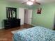 Spacious bedroom showing a dark dresser with mirror, bright window, and inviting atmosphere at 13031 W Surrey Ave, El Mirage, AZ 85335