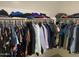 This walk-in closet has ample hanging storage and overhead storage for clothing at 13031 W Surrey Ave, El Mirage, AZ 85335