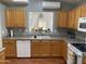 Kitchen offers functionality with plentiful cabinetry and an easy view into the dining area at 13031 W Surrey Ave, El Mirage, AZ 85335