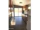 This kitchen boasts ample cabinet space, stainless steel sink, and backyard access at 13031 W Surrey Ave, El Mirage, AZ 85335