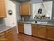 A well-lit kitchen showcasing ample wood cabinets and a seamless view into the dining area at 13031 W Surrey Ave, El Mirage, AZ 85335