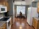Functional kitchen with a view into the cozy dining area for easy serving at 13031 W Surrey Ave, El Mirage, AZ 85335
