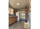 Neutral kitchen showcasing a refrigerator and sliding door access to the backyard at 13031 W Surrey Ave, El Mirage, AZ 85335