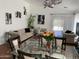 Open-concept living area with tufted sofas and a glass dining table with seating for six at 13031 W Surrey Ave, El Mirage, AZ 85335