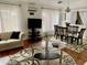Cozy living room with a TV and glass tables providing comfort and style at 13031 W Surrey Ave, El Mirage, AZ 85335