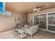 Charming covered back patio with comfortable seating, ceiling fan, and beautiful outdoor decor at 13821 N Thunderbird Blvd, Sun City, AZ 85351