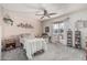 Cozy bedroom featuring a ceiling fan, carpet flooring, and a large sliding glass door to the outside at 13821 N Thunderbird Blvd, Sun City, AZ 85351