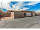 A well maintained exterior elevation with a block wall, private gate, and an attached single car garage at 13821 N Thunderbird Blvd, Sun City, AZ 85351