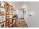 Bright hallway with white walls, wood-look tile flooring, and a decorative wood screen at 13821 N Thunderbird Blvd, Sun City, AZ 85351