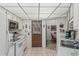 Functional white kitchen featuring tile flooring, ample counter space, and white appliances at 13821 N Thunderbird Blvd, Sun City, AZ 85351