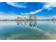 Expansive lake view featuring swaying palm trees on a clear day with light cloud cover creating stunning reflections at 13821 N Thunderbird Blvd, Sun City, AZ 85351