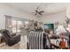 Comfortable living room with a ceiling fan, wood floors, and sliding glass door leading to the patio at 13821 N Thunderbird Blvd, Sun City, AZ 85351
