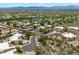 Overhead view of a desert community featuring residential homes, desert flora, and mountain views at 13850 N Mirage Heights Ct # 201, Fountain Hills, AZ 85268