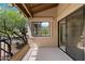 Private balcony with black iron railing, textured walls, and a view of mature desert landscaping at 13850 N Mirage Heights Ct # 201, Fountain Hills, AZ 85268