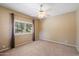 Spacious bedroom with a ceiling fan and a window overlooking the trees outside at 13850 N Mirage Heights Ct # 201, Fountain Hills, AZ 85268