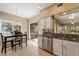 An eat-in kitchen with stainless steel appliances, granite countertops, and tile flooring at 13850 N Mirage Heights Ct # 201, Fountain Hills, AZ 85268