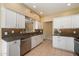 Kitchen featuring white cabinets, granite countertops, stainless steel appliances and tile flooring at 13850 N Mirage Heights Ct # 201, Fountain Hills, AZ 85268