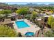 Relaxing pool and spa area surrounded by lounge chairs, desert landscaping, and mountain views at 13850 N Mirage Heights Ct # 201, Fountain Hills, AZ 85268