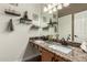 A view of a bathroom with double sinks, granite countertops, and bronze fixtures at 14282 W Indianola Ave, Goodyear, AZ 85395