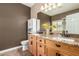Spacious bathroom with granite counters, double sinks, and decorative sunflowers at 14282 W Indianola Ave, Goodyear, AZ 85395