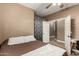 Neutral-toned bedroom with desk, ceiling fan, and views to the hall and closet at 14282 W Indianola Ave, Goodyear, AZ 85395