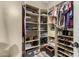 View of an organized walk-in closet with shelves and hanging storage space at 14282 W Indianola Ave, Goodyear, AZ 85395