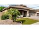 Charming single-story home with a well-manicured lawn, desert landscaping, and a cozy front porch at 14282 W Indianola Ave, Goodyear, AZ 85395