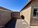 Side yard view of the house showing gravel, stepping stones, a shed, and exterior walls at 14282 W Indianola Ave, Goodyear, AZ 85395