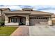 Charming single-story home with a well-manicured lawn and a two car garage at 14282 W Indianola Ave, Goodyear, AZ 85395