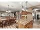 Open-concept kitchen features a large island, wood cabinets, and adjacent dining area with modern lighting at 14282 W Indianola Ave, Goodyear, AZ 85395