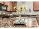 Close up of granite kitchen island with cookies and natural light from backyard window at 14282 W Indianola Ave, Goodyear, AZ 85395