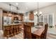 Open kitchen and dining area featuring a large wooden table and island with seating at 14282 W Indianola Ave, Goodyear, AZ 85395