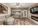 Cozy living room showcasing wood-look flooring, a modern fireplace, and a comfortable sectional sofa at 14282 W Indianola Ave, Goodyear, AZ 85395