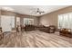 Inviting living room with wood-look floors, a ceiling fan, and bright windows at 14282 W Indianola Ave, Goodyear, AZ 85395
