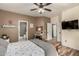 Spacious main bedroom with ceiling fan, en suite bathroom, and walk-in closet at 14282 W Indianola Ave, Goodyear, AZ 85395