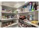 This pantry is equipped with shelving and stocked with food at 14282 W Indianola Ave, Goodyear, AZ 85395