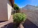 Compact side yard featuring low-maintenance gravel and an AC unit surrounded by greenery next to the house at 1516 E Azalea Dr, Gilbert, AZ 85298