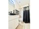 Modern bathroom featuring a sleek black vessel sink, neutral tile flooring, and a combined shower and tub at 1516 E Azalea Dr, Gilbert, AZ 85298