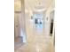 Inviting hallway featuring neutral tile floors and views into the living space at 1516 E Azalea Dr, Gilbert, AZ 85298
