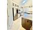 Well-equipped kitchen with a stainless steel refrigerator, white cabinets, and a convenient center island at 1516 E Azalea Dr, Gilbert, AZ 85298